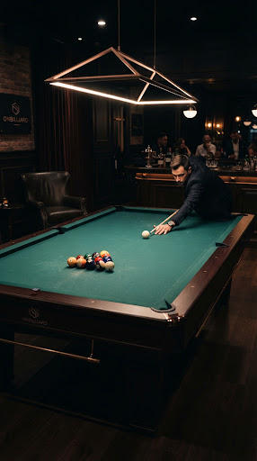 Billiard table under dramatic overhead lighting